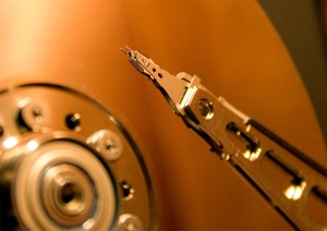 Hard disk head suspened over disk platter